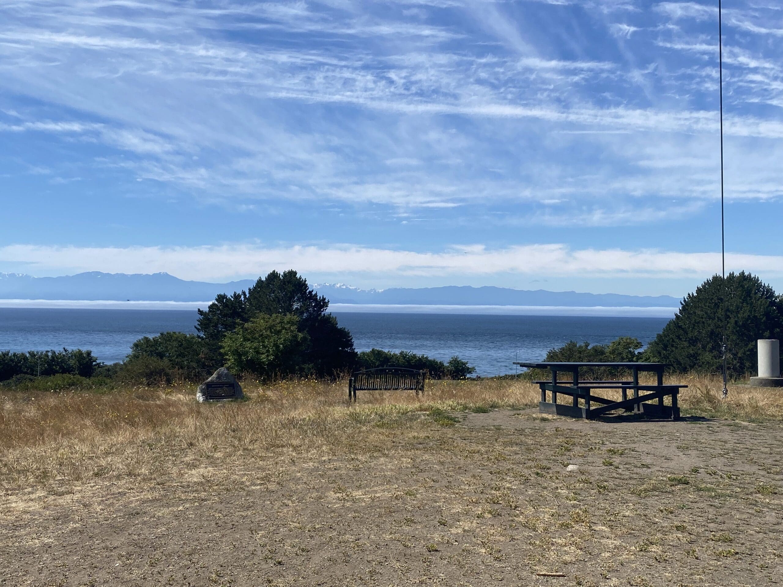 View from Beacon Hill overlooking the Straight of Juan De Fuca. There is a picnic table and bench to enjoy the view.