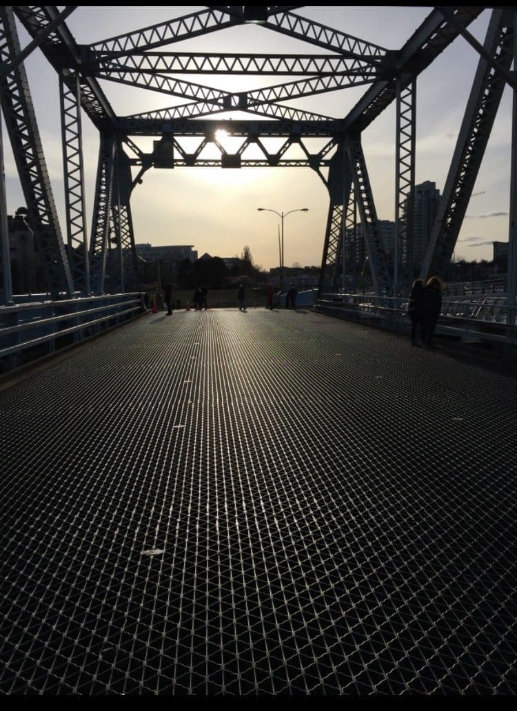 People walking on the old bridge, the day it became no longer in service - this is the Blue Bridge sunset picture.
