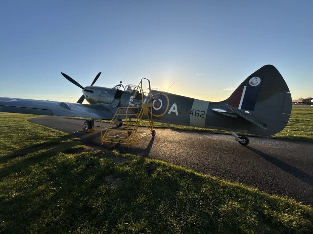The spitfire with a beautiful sun in the background.