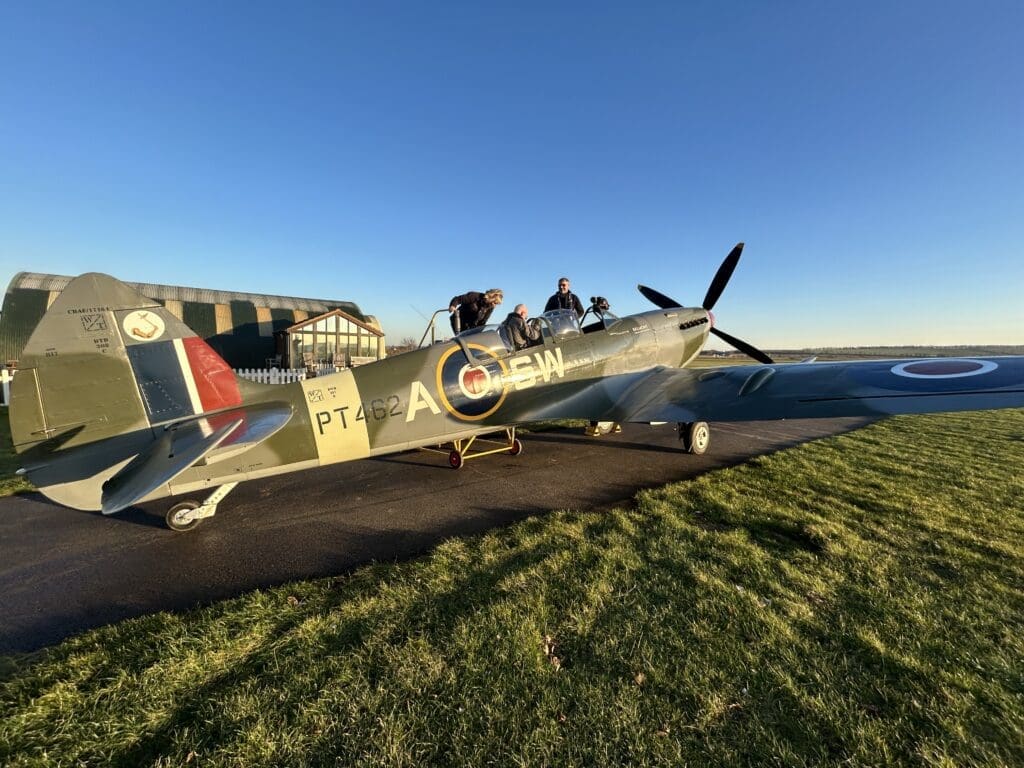 In Duxford, getting the aircraft and passenger ready for flight. Safety first!